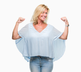 Fototapeta premium Middle age blonde business woman over isolated background showing arms muscles smiling proud. Fitness concept.