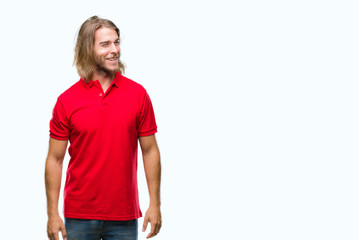 Young handsome man with long hair over isolated background looking away to side with smile on face, natural expression. Laughing confident.