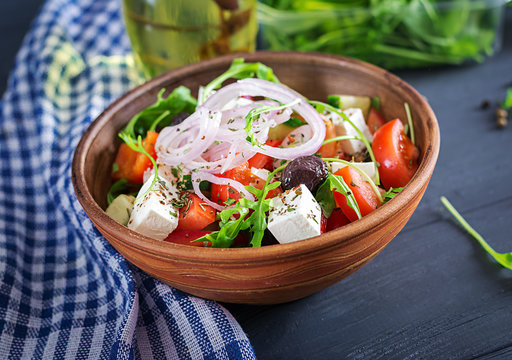 Greek salad with fresh tomato, cucumber, red onion, basil, feta cheese, black olives and Italian herbs