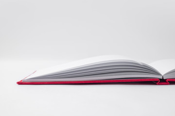Perspective red notebook with open page