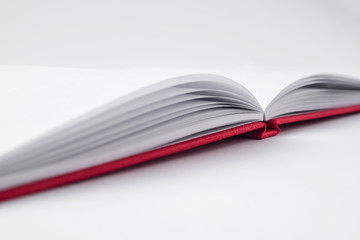 Perspective red notebook with open page