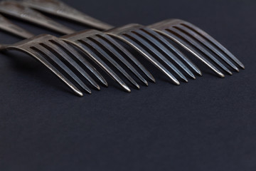 vintage old forks close up on dark background