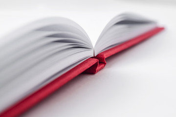Perspective red notebook with open page