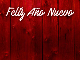 szczęśliwego nowego roku na czerwonym tle z desek po hiszpańsku