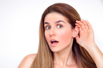 Fototapeta premium Beautiful woman listening with her hand to her ear