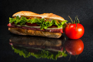 sandwich with tomato on black background