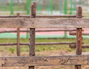 Fototapeta na wymiar Wooden planks on the fence in the park