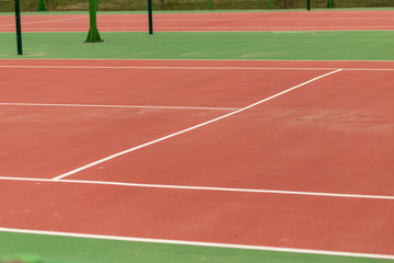 Tennis court in the park as a background