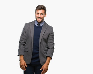 Young handsome business man over isolated background looking away to side with smile on face, natural expression. Laughing confident.