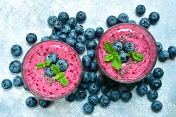Blueberry and banana smoothie with mint and chia seed in a glasses.Top view with copy space.