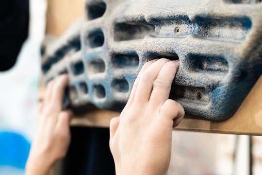 Training fingers on the fingerboard at the climbing gym