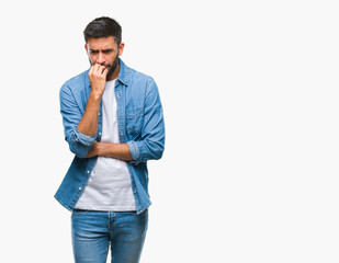 Adult hispanic man over isolated background looking stressed and nervous with hands on mouth biting...