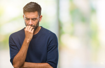 Adult hispanic man over isolated background looking stressed and nervous with hands on mouth biting nails. Anxiety problem. - obrazy, fototapety, plakaty