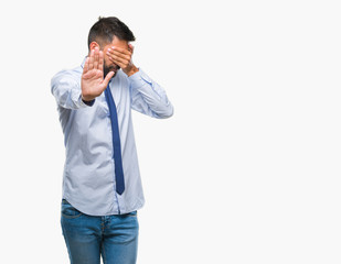 Adult hispanic business man over isolated background covering eyes with hands and doing stop gesture with sad and fear expression. Embarrassed and negative concept.