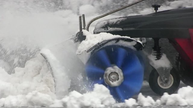 Snow thrower for snow removal in the winter. Man Removing Snow. Heavy precipitation and snow piles concept