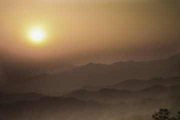 Fototapeta na wymiar mountains of China in the vicinity of Beijing air is saturated smog-red sunset