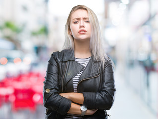 Fototapeta na wymiar Young blonde woman wearing fashion jacket over isolated background skeptic and nervous, disapproving expression on face with crossed arms. Negative person.