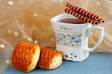 A cup of tea with delicious sweets on the table