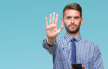 Young hadsome man texting sending message using smartphone over isolated background with open hand doing stop sign with serious and confident expression, defense gesture