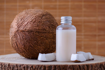 Obraz na płótnie Canvas diy cosmetic bottle and fresh organic coconut , natural background