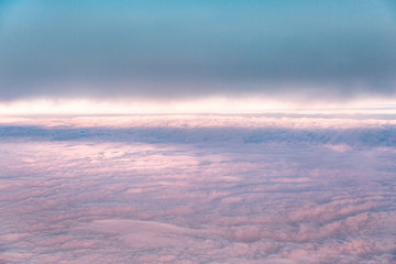 Blue sky background with pink homogeneous clouds