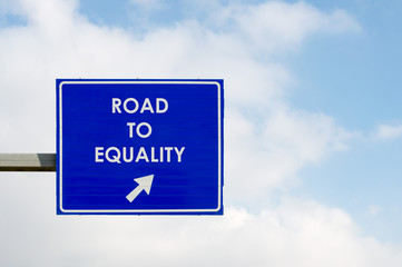 Road to Equality words displayed on blue road sign