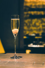 Champagne cocktail with lychee in a flute