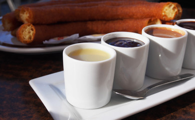 Typical Spanish snack churros are deep-fried pastries and served with hot chocolate everywhere in Spain. Churros con chocolate is a classic Spanish breakfast