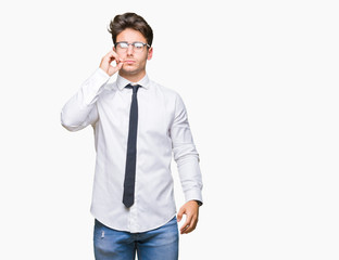 Young business man wearing glasses over isolated background mouth and lips shut as zip with fingers. Secret and silent, taboo talking
