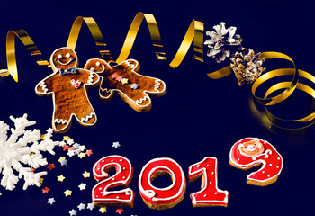 New Year card on blue background gingerbread red numbers 2019 with multi-colored stars, gingerbread Mans
