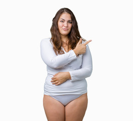 Beautiful plus size young overwight woman wearing white underwear over isolated background Pointing...