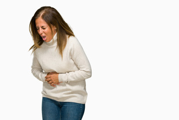 Beautiful middle age adult woman wearing winter sweater over isolated background with hand on stomach because nausea, painful disease feeling unwell. Ache concept.