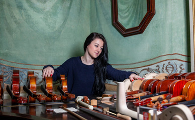 Fascinating violinist showing his collection of handcrafted violins
