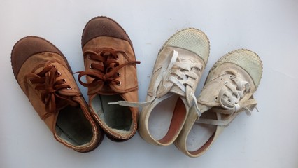 Old white and brown student shoes..white background.