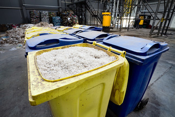 Modern waste processing and sorting plant. Containers with shredded plastic prepared for further processing remelting and recycling