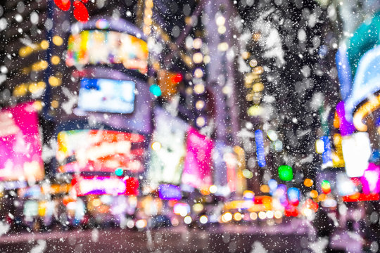 Defocused Blur Times Square  New York City  Manhattan Street Scene With Cars , Lights And Snowflakes Falling During Winter Snow Storm