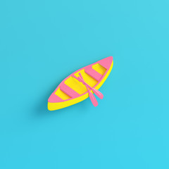 Yellow canoe with paddles on bright blue background in pastel colors