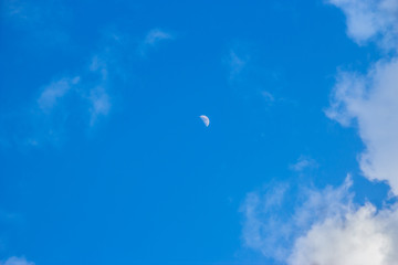 blue sky with clouds and moon