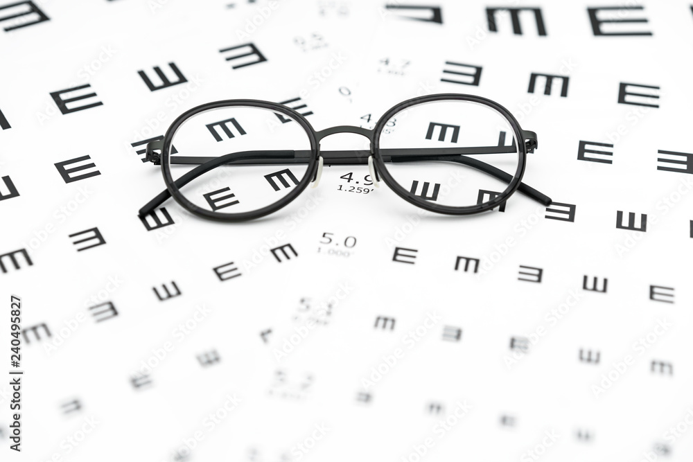 Wall mural Eyeglasses and visual acuity chart in white background