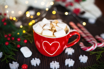 Cup of hot chocolate with marshmallow. Red cup with white heart.