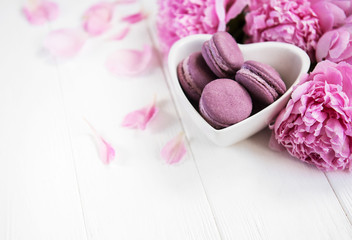 Pink peony flowers with macarons