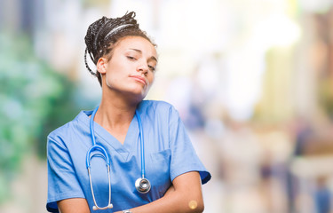 Young braided hair african american girl professional surgeon over isolated background skeptic and nervous, disapproving expression on face with crossed arms. Negative person.