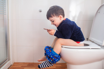 boy with phone in bathroom