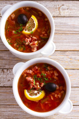 Russian dish  solyanka - thick, spicy and sour saltwort soup. overhead, vertical