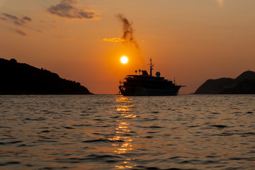 silhouette of a ship during golden sunset