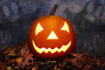 Glowing Halloween pumpkin in heap of leaves with ghosts on background