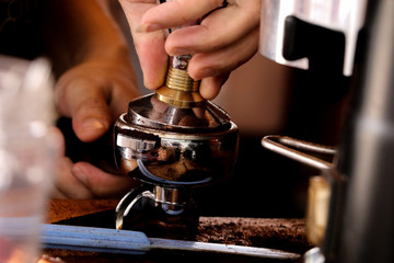 Fototapeta na wymiar Process pressing ground coffee with tamper
