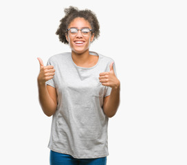 Young afro american woman wearing glasses over isolated background success sign doing positive gesture with hand, thumbs up smiling and happy. Looking at the camera with cheerful expression