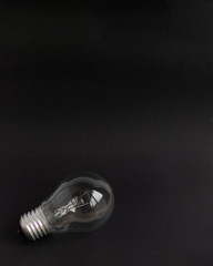 Bulb on black background. Mockup for design. Copy space.