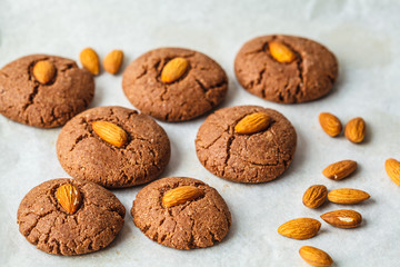 Chocolate cookies with almonds on white background. Vegan dessert concept.